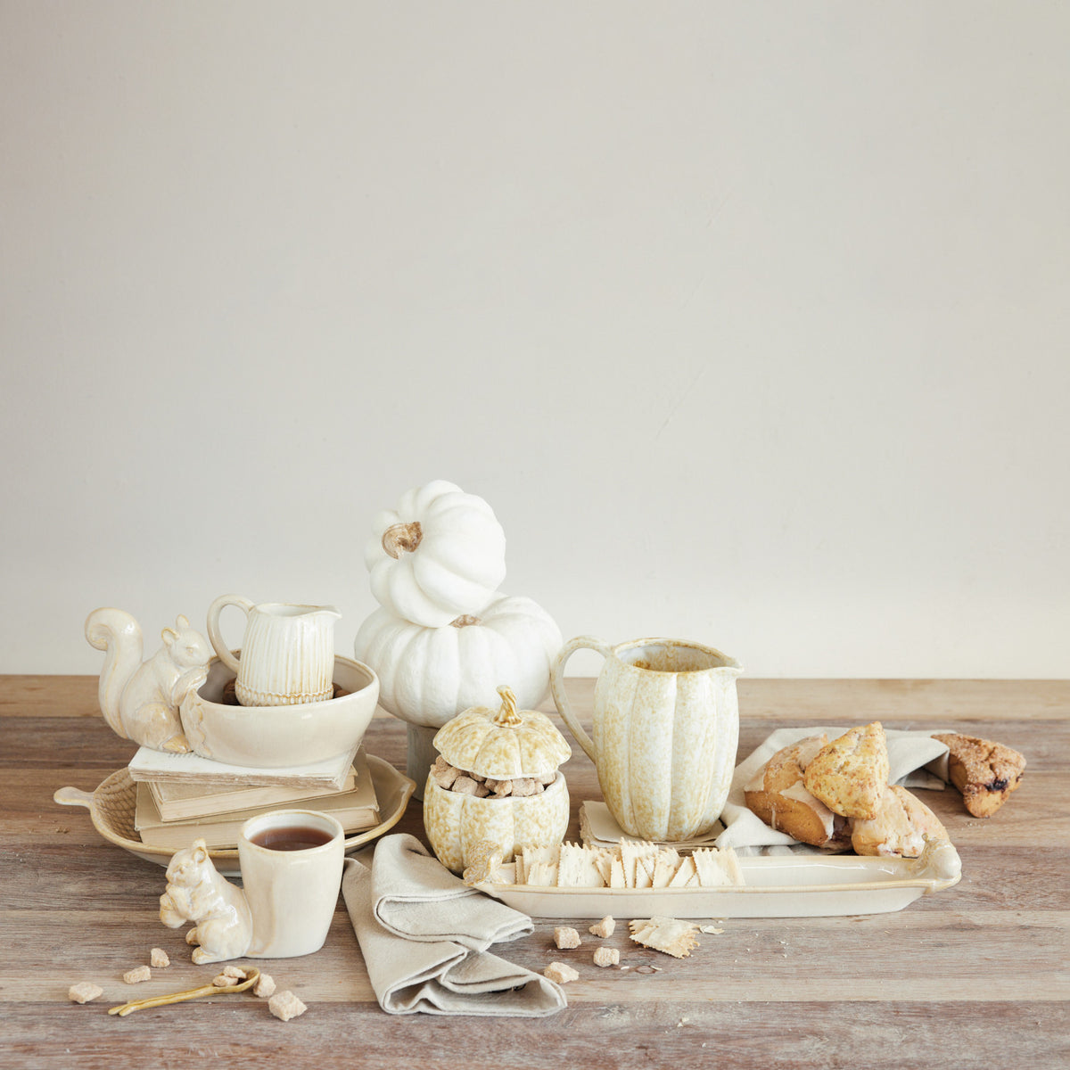 Stoneware olive dish with 3D acorn details on a rustic table with fall-themed ceramics.