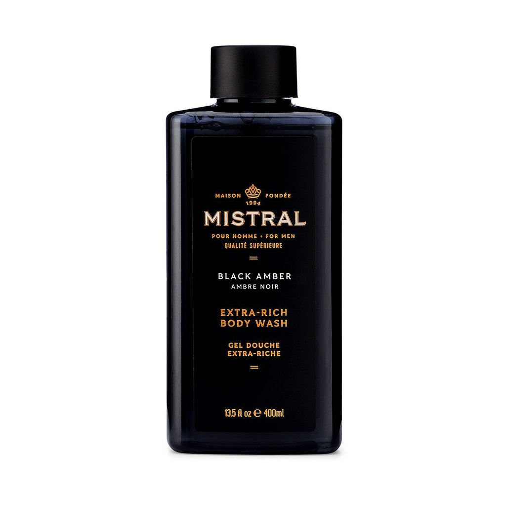 Mistral Black Amber Extra-Rich Body Wash in a 13.5 fl oz black rectangular bottle.