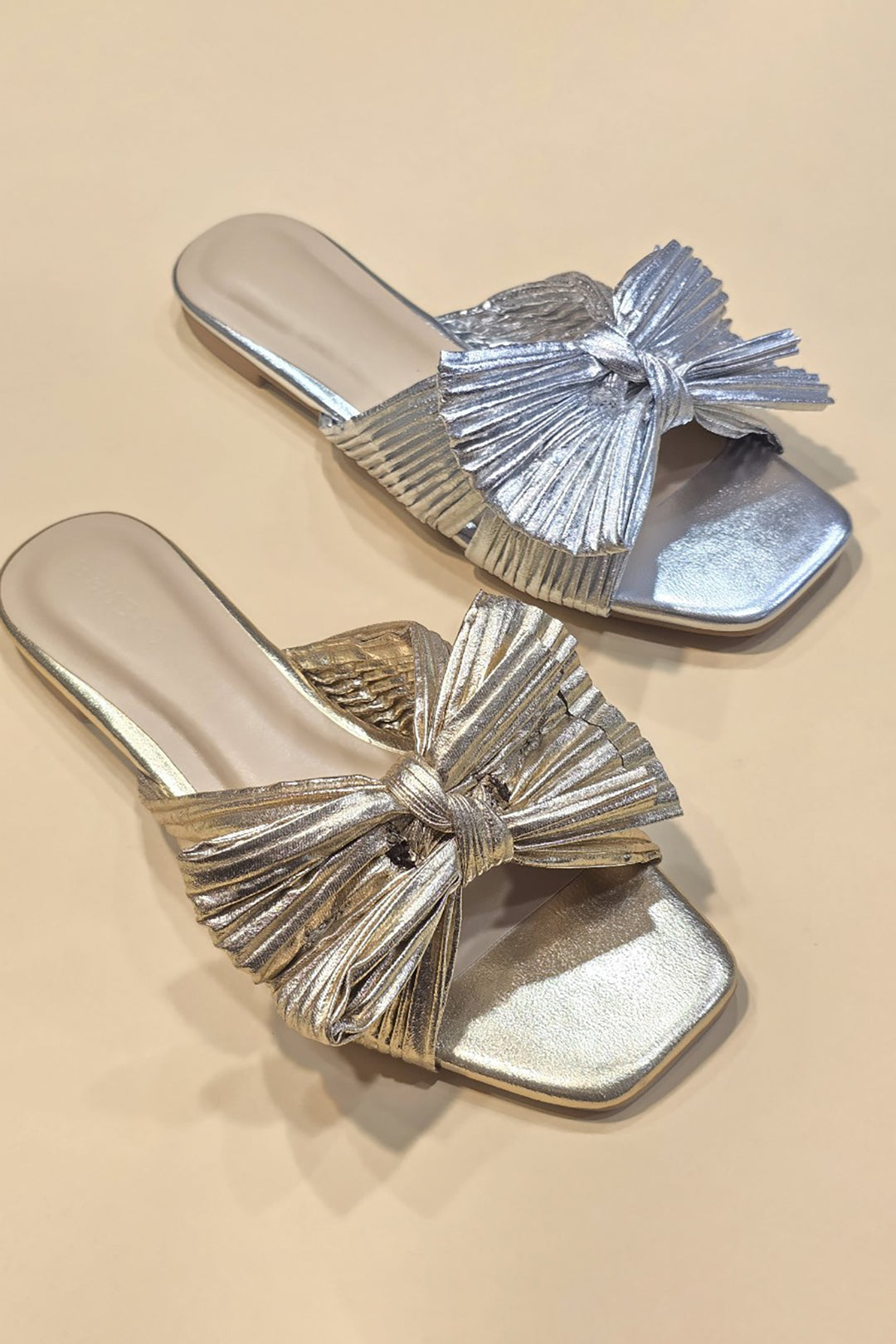 Metallic fabric ribbon slide flat sandals with a sleek strap across the toes.
