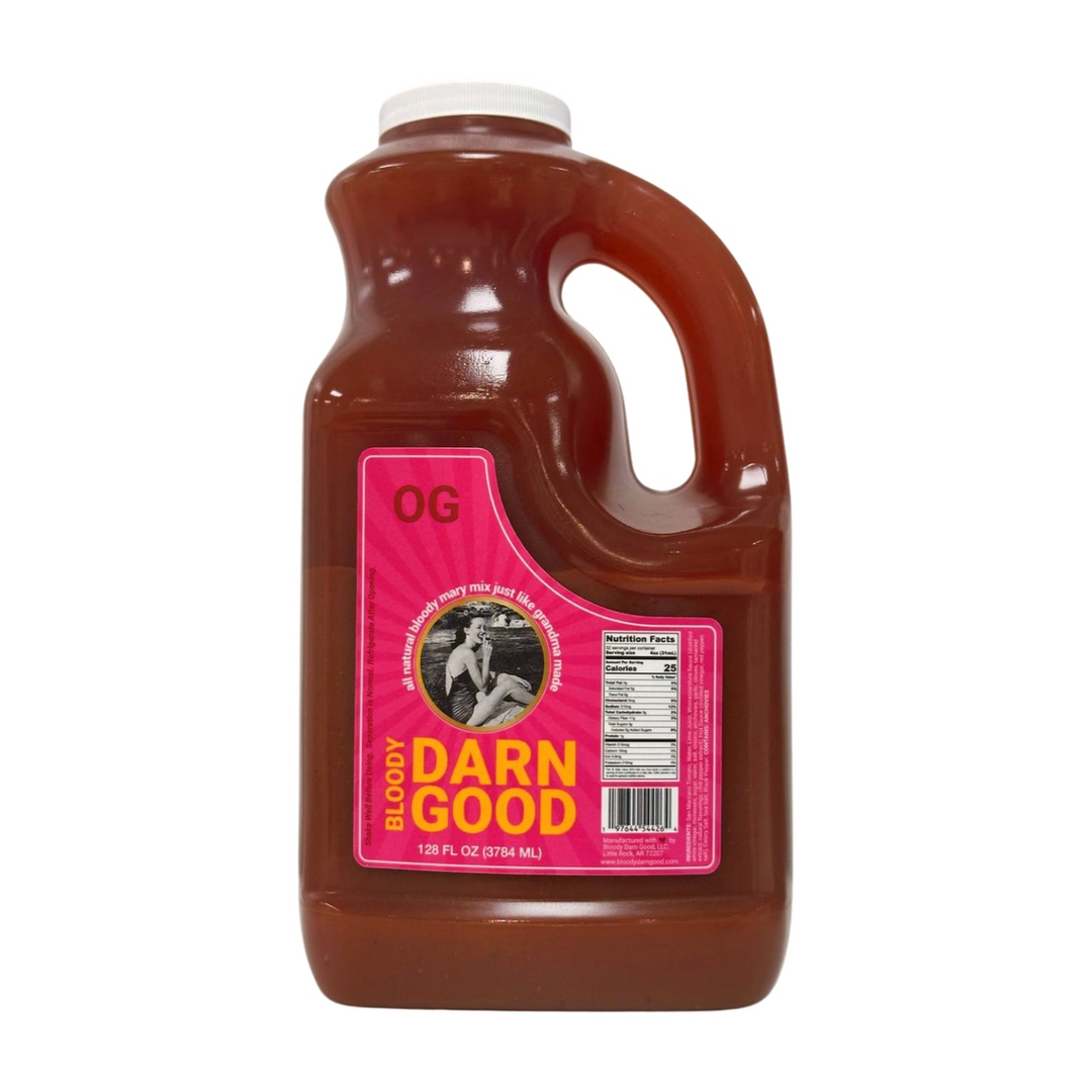 A one-gallon jug of OG Bloody Darn Good Bloody Mary Mix with a pink and yellow label.