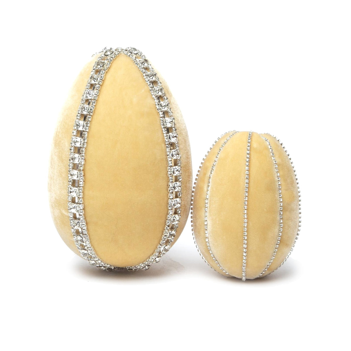 Two velvet eggs, one large and one small, in a pale yellow color, adorned with sparkling rhinestone trim.