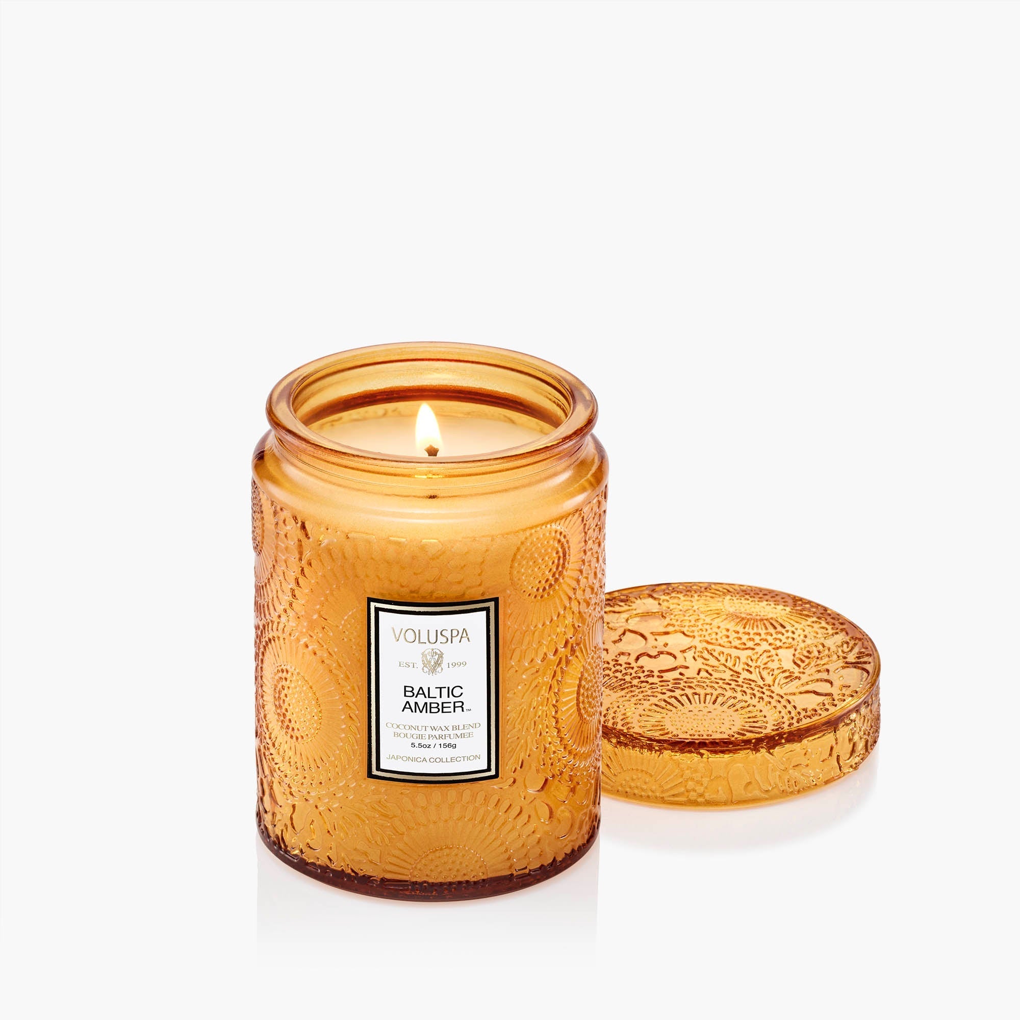 Small jar candle with Baltic amber wax, natural wick, and vegan soy blend in a clear glass container.