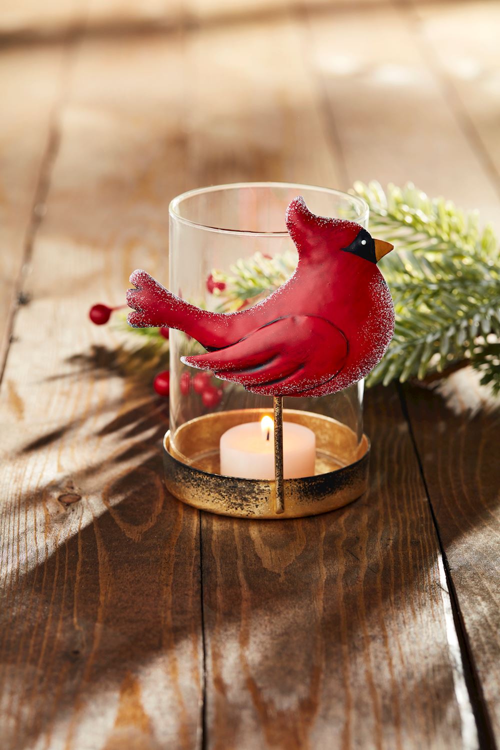 Cardinal Votive candle holder with a red metal bird figure on a glass cylinder and gold base.