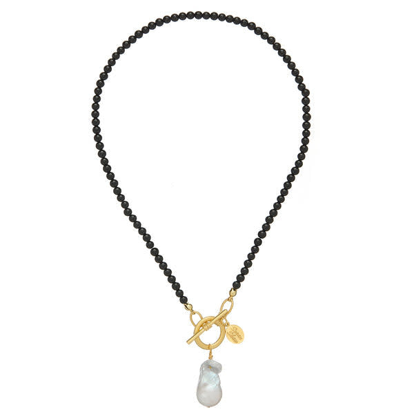 Katie necklace featuring black onyx beads with a baroque pearl accent and gold toggle clasp.