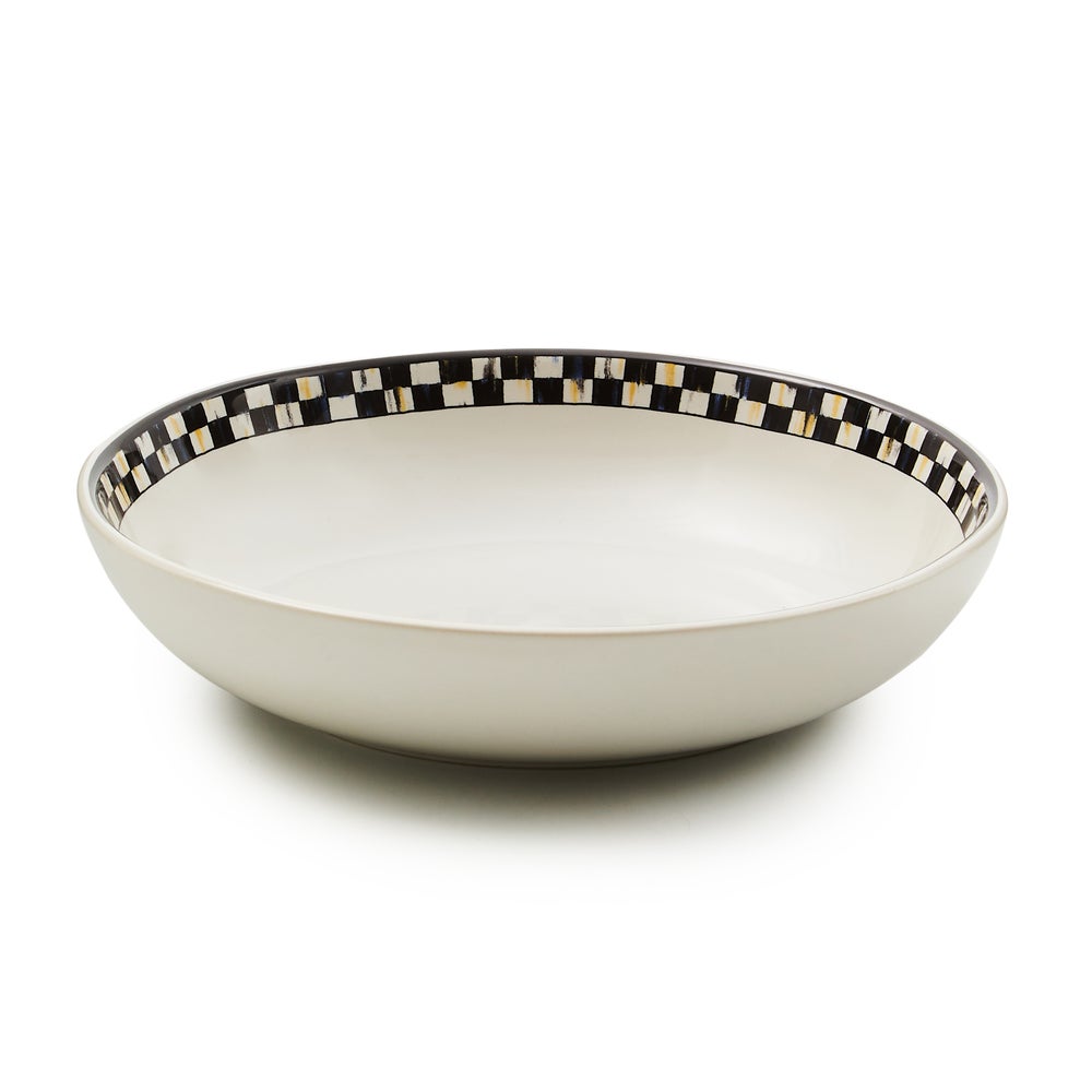 White stoneware pasta bowl with a black and white checkered pattern around the inner rim.