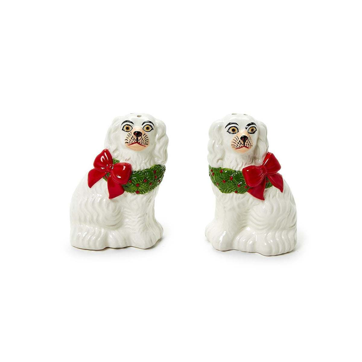 Ceramic salt and pepper shakers shaped as a black Staffordshire dog holding a green wreath.