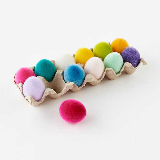 A white flocked egg-shaped ornament measuring approximately 2.5 inches tall.