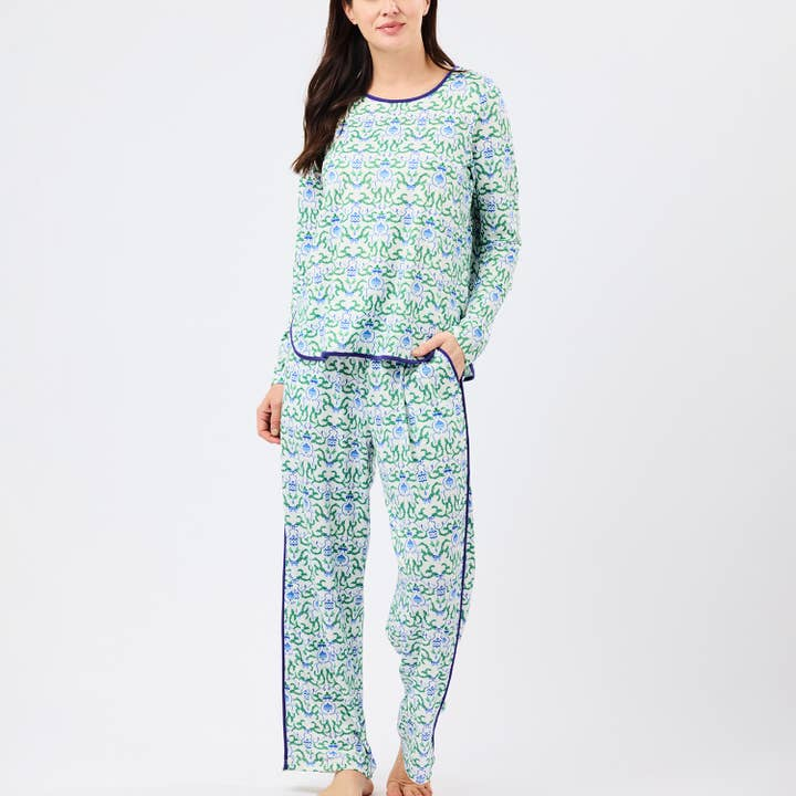 Woman wearing Pajamas Melody Long Sleeve Long Pants set with a green and blue floral pattern.