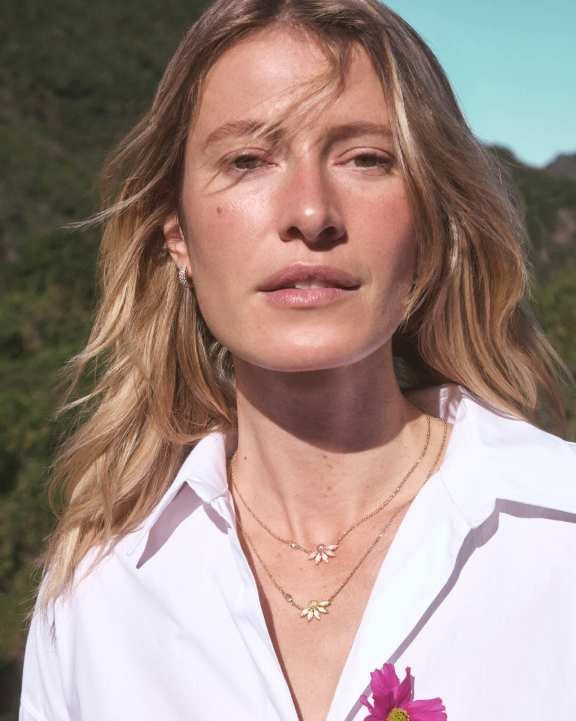 Anya Flower short pendant necklace in gold with petal-shaped stones, crystal accents, and a lobster clasp chain.