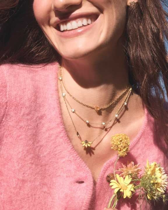 Anya Flower short pendant necklace in gold over brass with white cubic zirconia accents and a lobster clasp.
