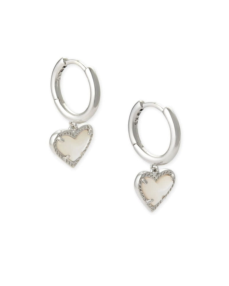 Rhodium over brass huggie earrings featuring a platinum drusy heart charm with an asymmetrical hinge closure.