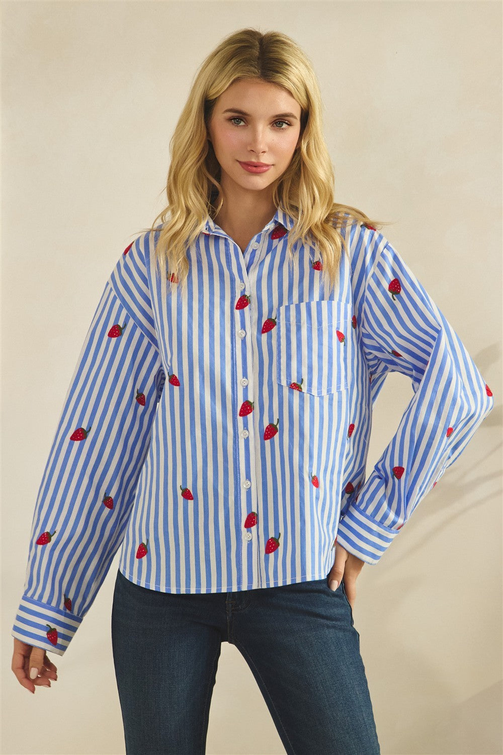 Eleanor button-down blouse in white cotton with red strawberry embroidery on the chest.