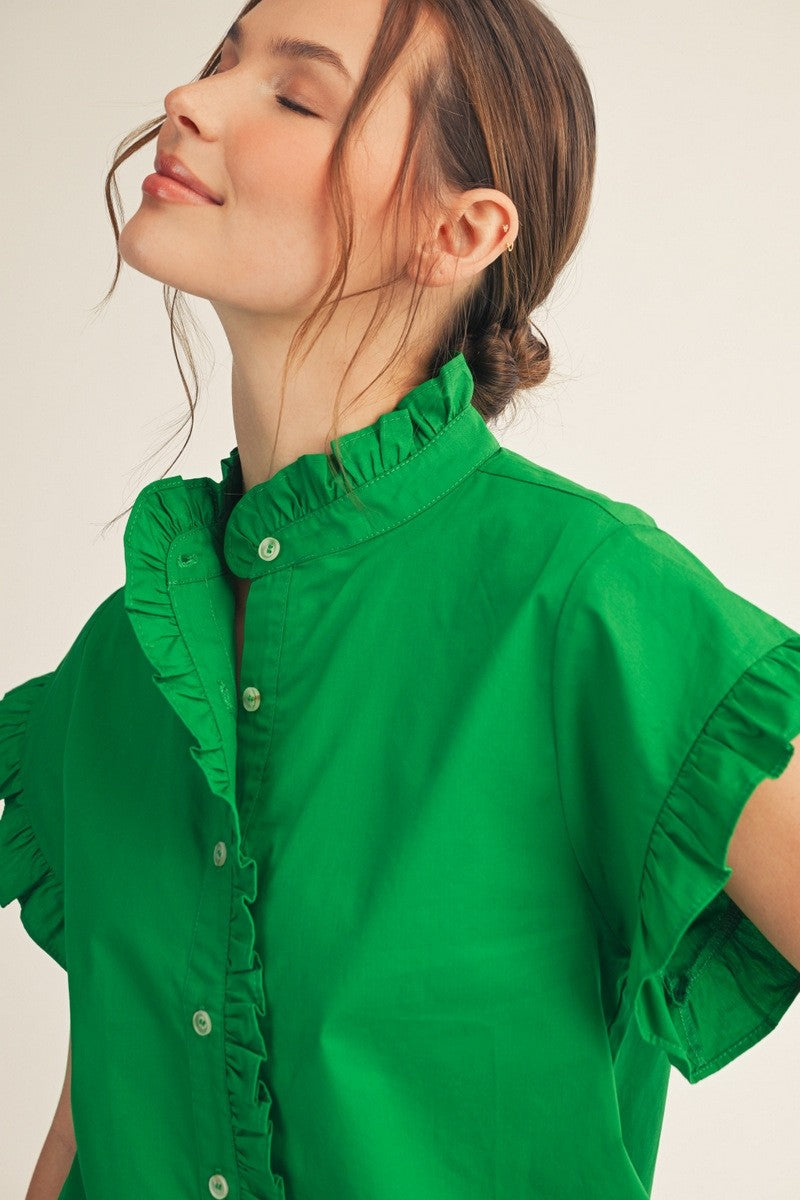 Woman wearing a bright green Elise Ruffled Detail Woven Top with a high ruffled collar.