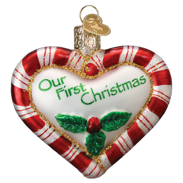 Red heart-shaped peppermint ornament with white polka dots on a gold string.