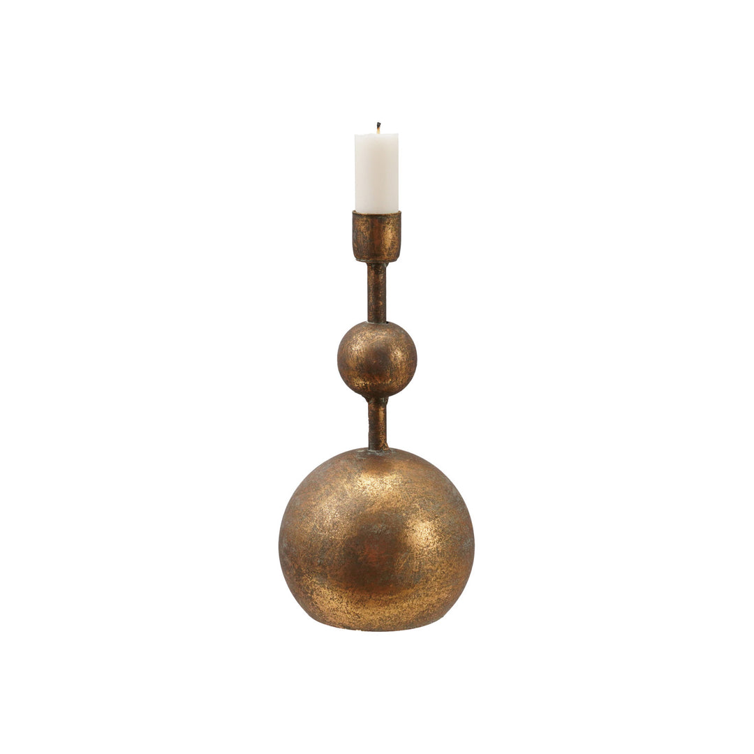 Antique gold metal taper candle holder with a sculptural stacked ball design and a white candle.