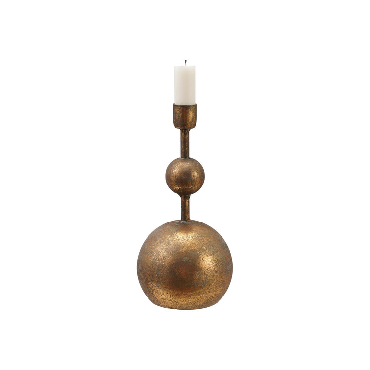 Antique gold metal taper candle holder with a sculptural stacked ball design and a white candle.