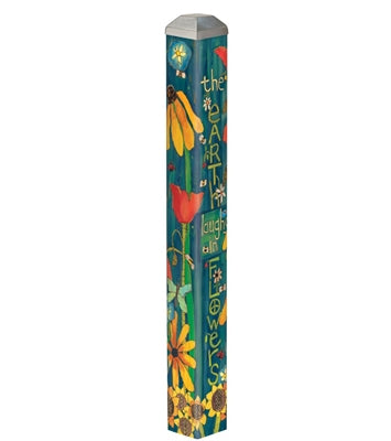 A 16-inch mini art pole with a teal background, painted with sunflowers, tulips, and daisies, and the words "the earth laughs in flowers."