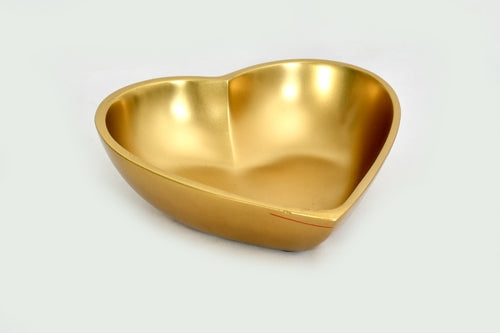 Large heart-shaped bowl made of polished gold-finished aluminum on a white background.
