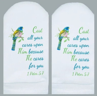 White no-show socks featuring a colorful bird and the Bible verse 1 Peter 5:7 in green and blue.