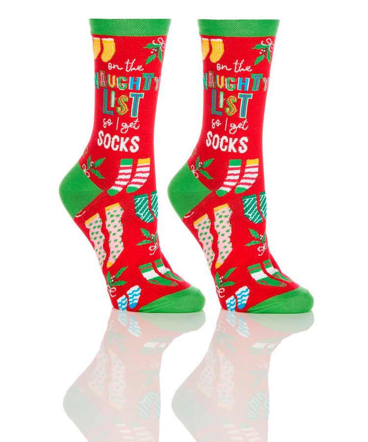 Women's crew socks in red with green accents featuring 'on the naughty list so I get socks' text.