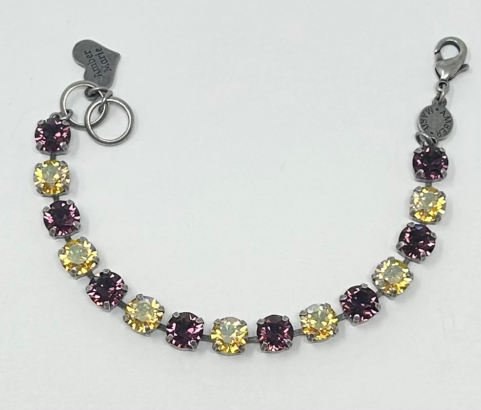 Classic New Orleans bracelet featuring green, yellow, purple stones with an amber tag and Scotty dog heart charm.