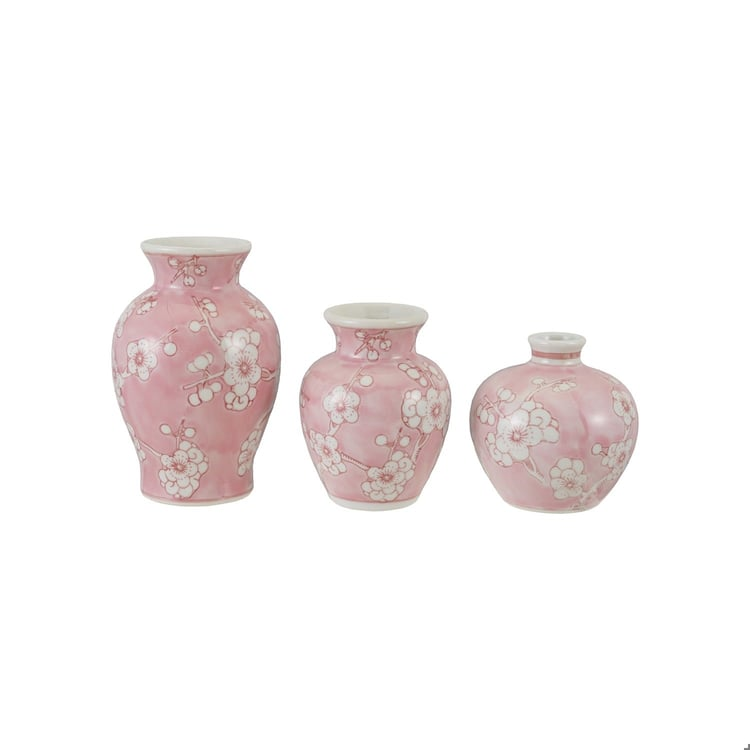 Three hand-painted pink stoneware vases with white cherry blossom designs in varying sizes.
