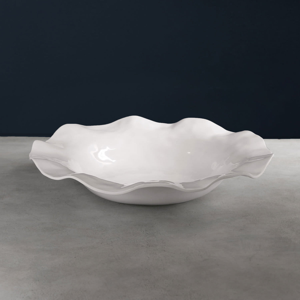 VIDA Havana extra large white melamine bowl with a wavy, ruffled rim on a grey surface.