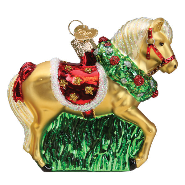 Glass horse ornament with a gold body, red saddle, and a green wreath around its neck.