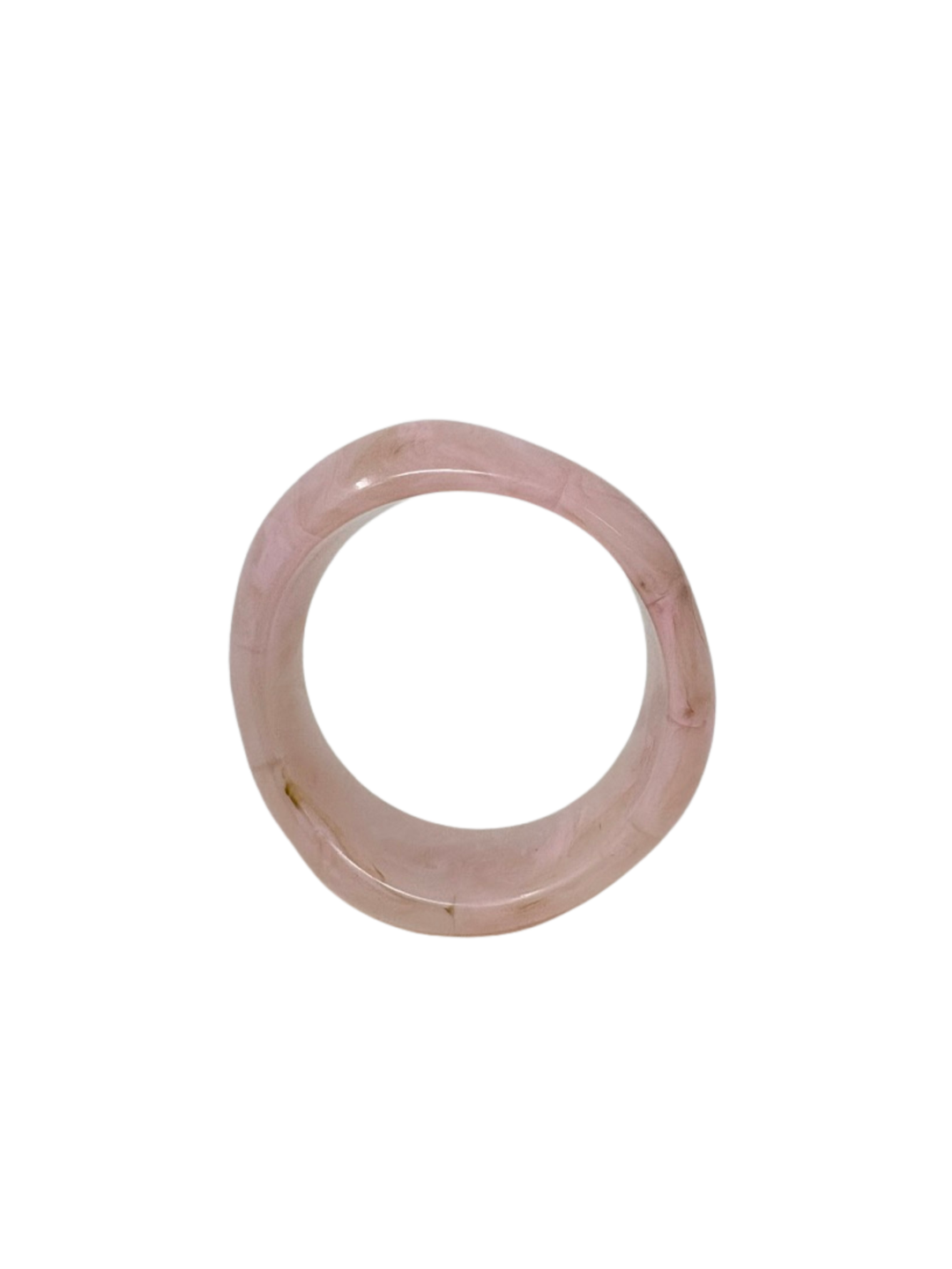 A thick, light pink marbled acrylic bangle bracelet shown from a top-down perspective.