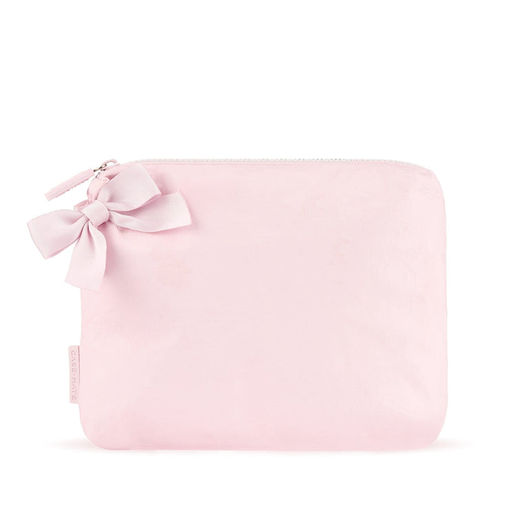 Light pink crinkle makeup bag with a matching bow detail and zip closure.