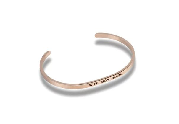 Rose gold cuff bracelet engraved with the text WIFE. MOM. BOSS.