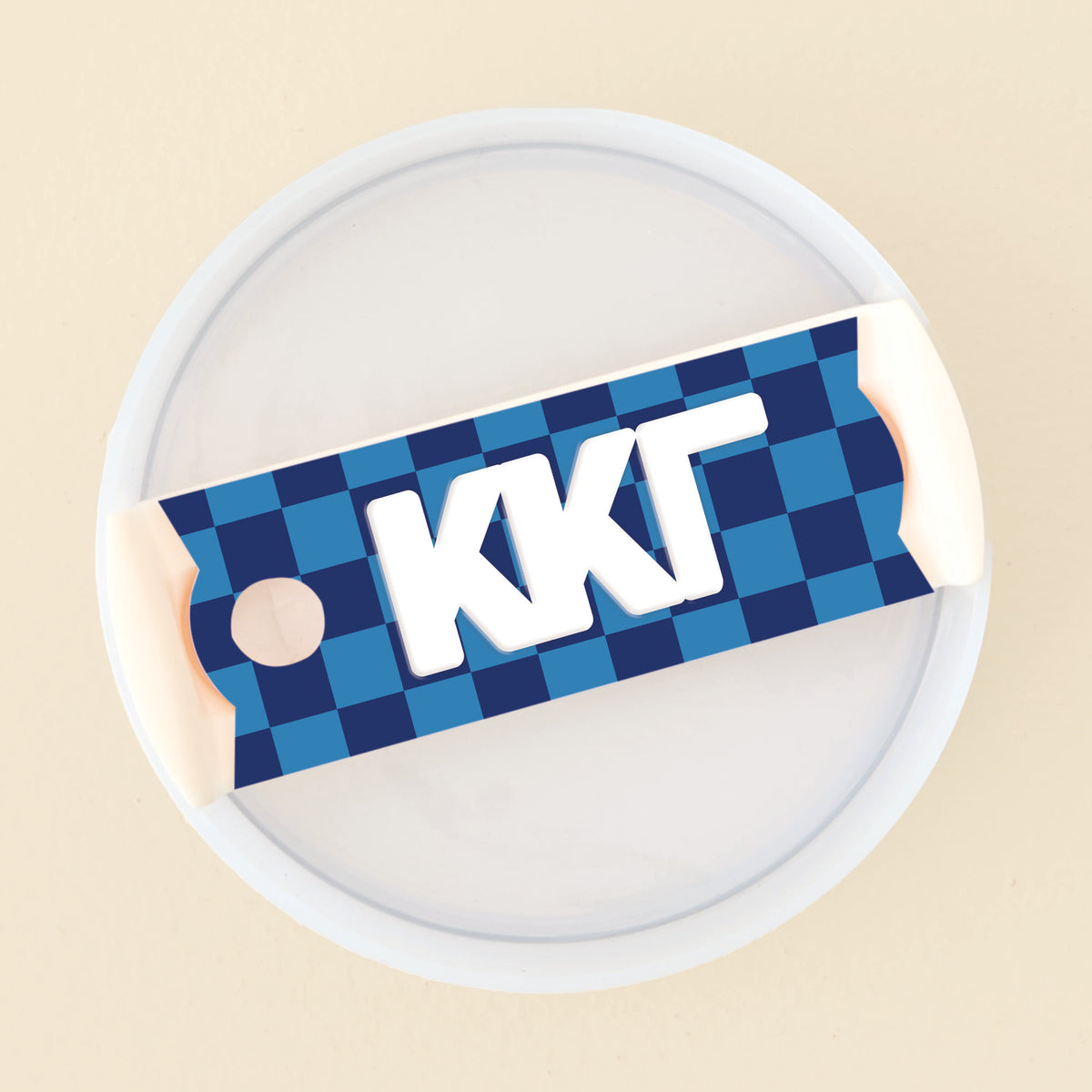 Blue checkered acrylic tumbler lid tag with white Kappa Kappa Gamma Greek letters.