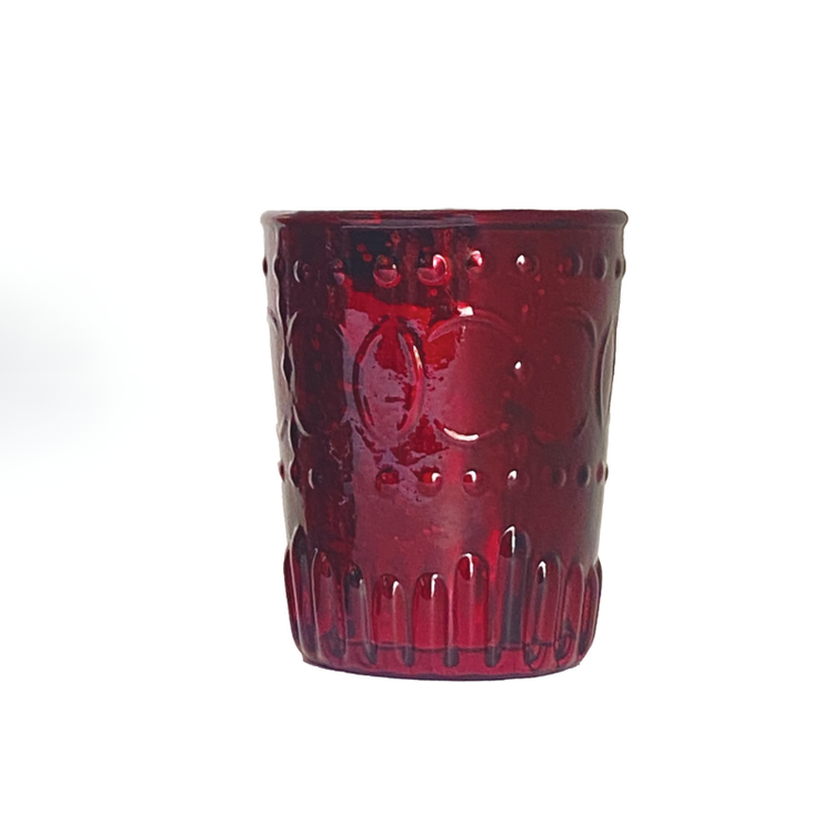 Red embossed mercury glass votive holder with textured patterns on a white background.