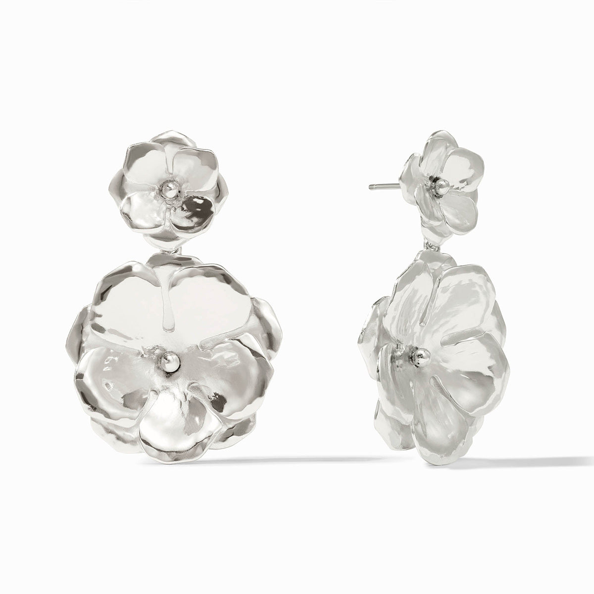 Silver Bloom Statement Earrings featuring two tiered, sculptural metallic flower drops.