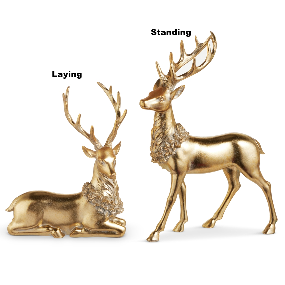 Two gold deer figurines with wreaths around their necks, one standing and one laying.