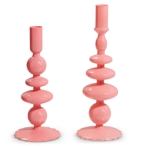 Pink glass candle stick with a simple cylindrical shape.