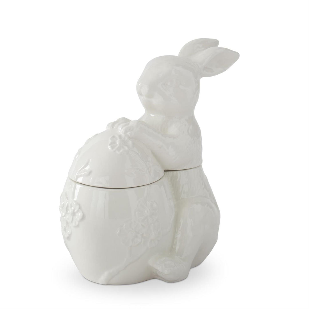White dolomite ceramic egg-shaped container with embossed flower patterns.