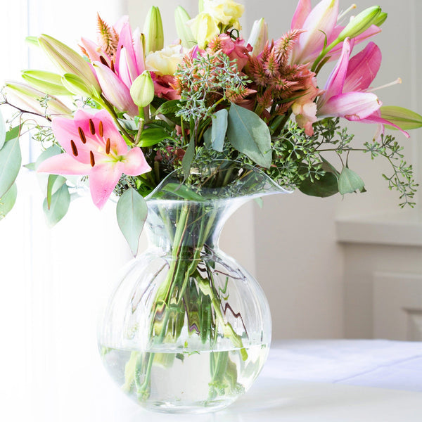 Large clear glass fluted vase with a wide mouth and tapered base
