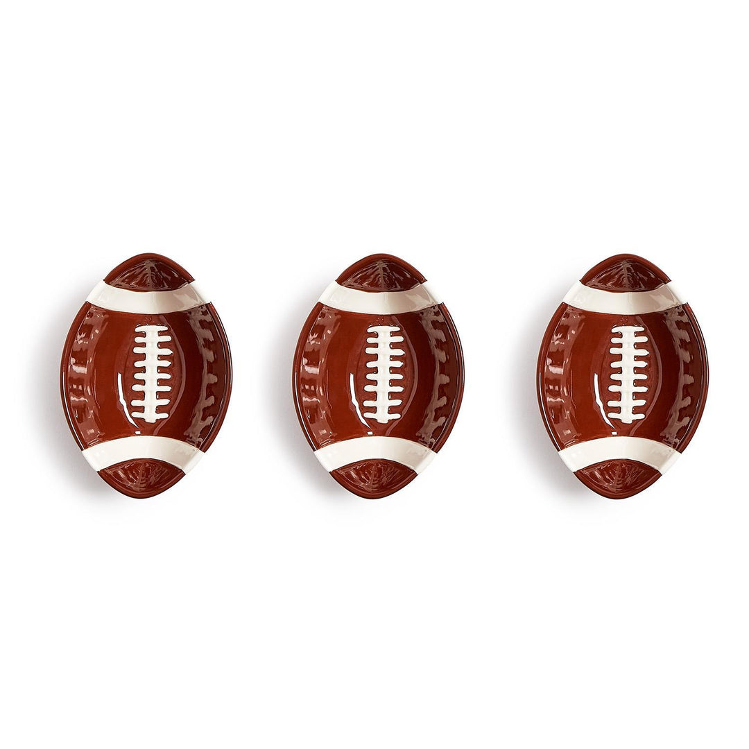 Three football-shaped ceramic tidbit bowls with brown glaze and white lace details.