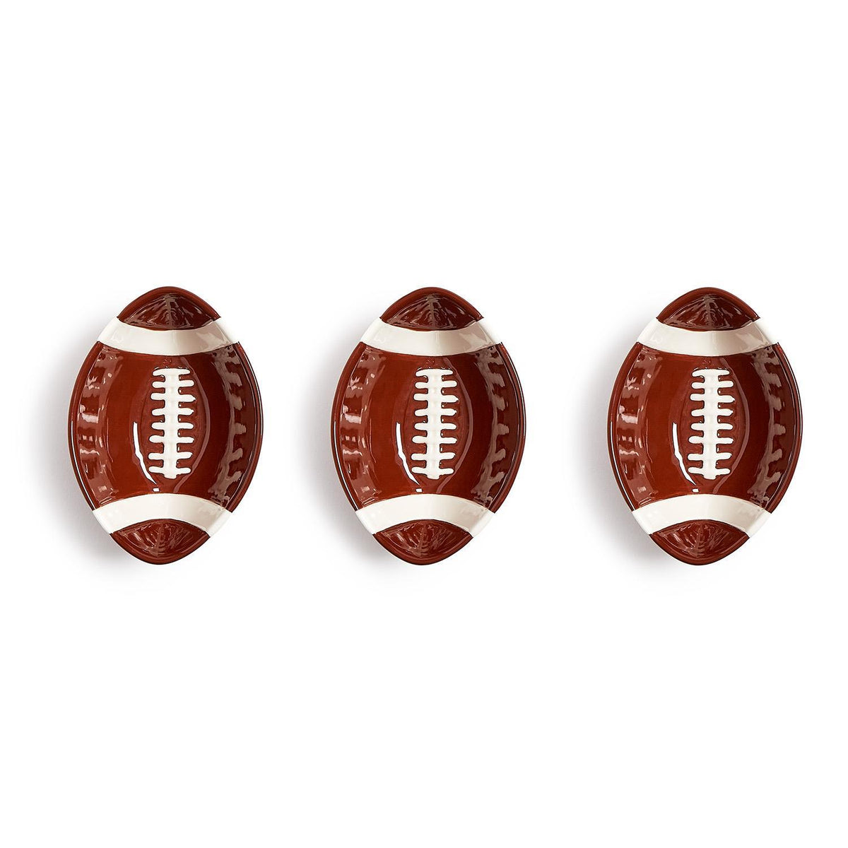 Three football-shaped ceramic tidbit bowls with brown glaze and white lace details.