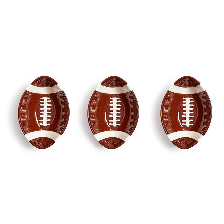 Three football-shaped ceramic tidbit bowls with brown glaze and white lace details.