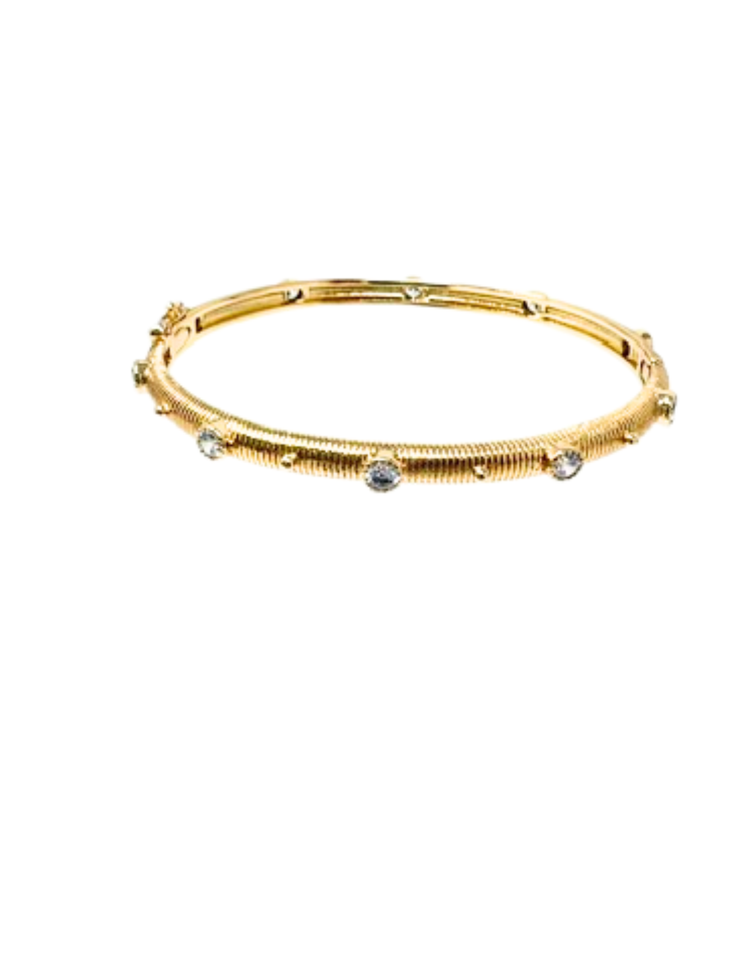 Gold-dipped textured bangle bracelet featuring round-cut cubic zirconia stones in bezel settings.