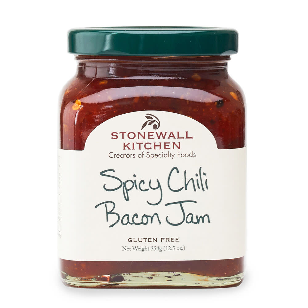 Jar of spicy chili bacon jam with visible red peppers and bacon bits.