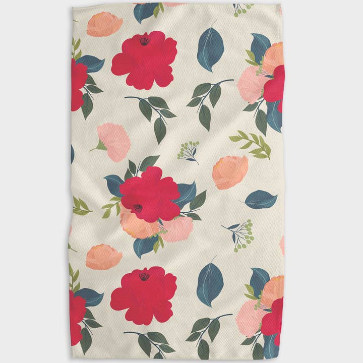 Waffle weave tea towel with a floral pattern of red and pink flowers and blue-green leaves.