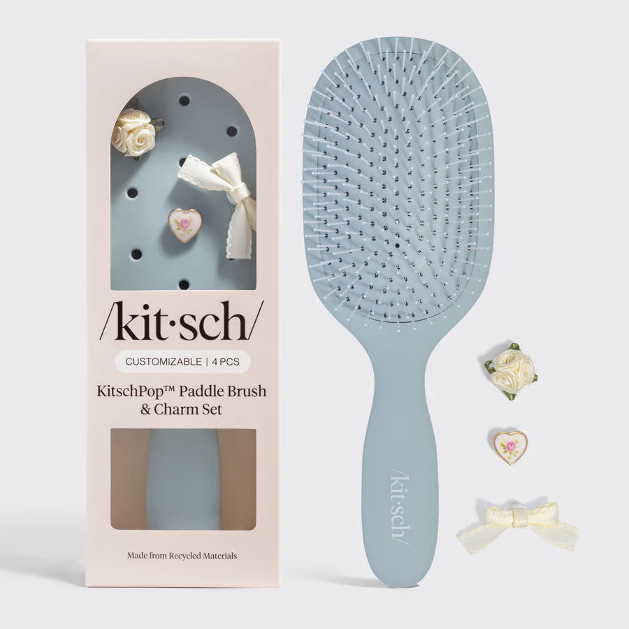 Black paddle brush with flexible bristles on a white background