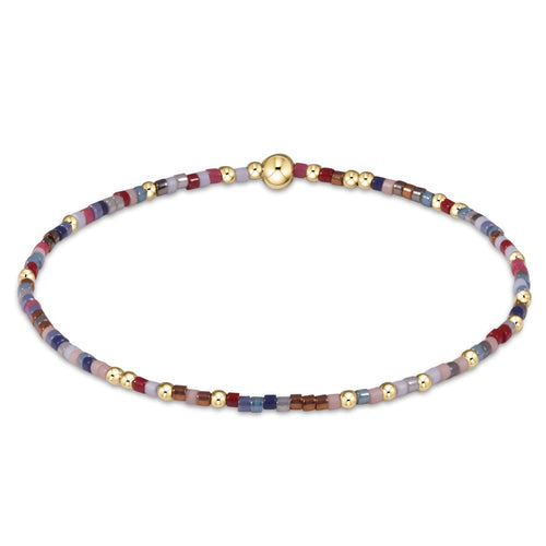 Hope Unwritten bracelet featuring mixed 2mm seed beads in various colors with gold-filled accents on elastic cord.