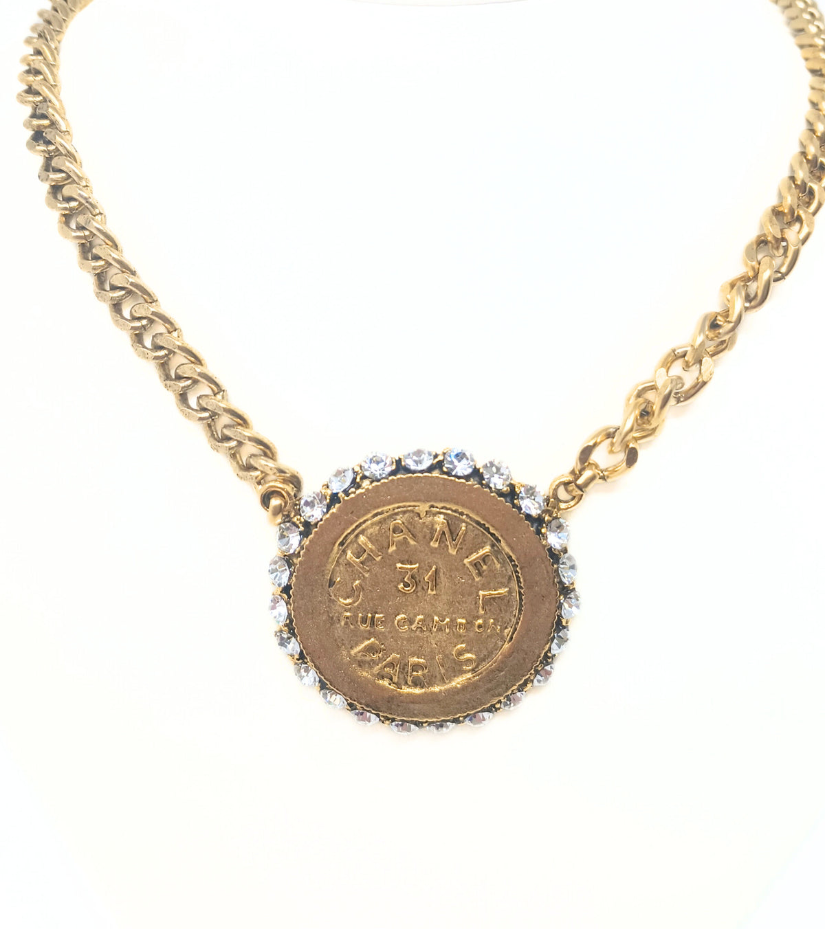 18-inch gold chain necklace featuring a designer-inspired coin pendant with rhinestone border.