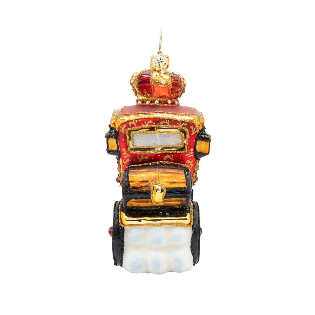 Rear view of a red and gold Yuletide Carriage glass ornament with a crown on top and white snow.