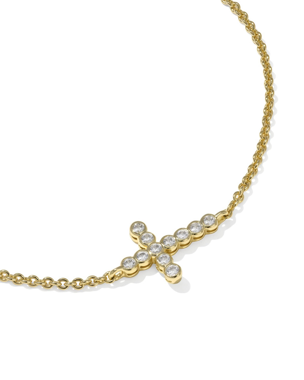 Delicate rhodium over brass chain bracelet with white cubic zirconia cross pendant and adjustable slider.