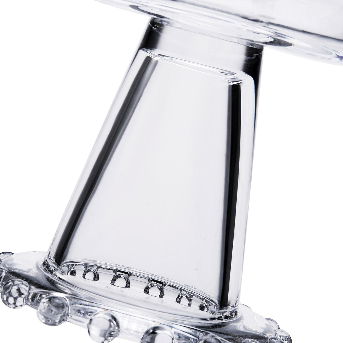 Close-up of a clear glass beaded dessert bowl pedestal base with a decorative beaded rim.